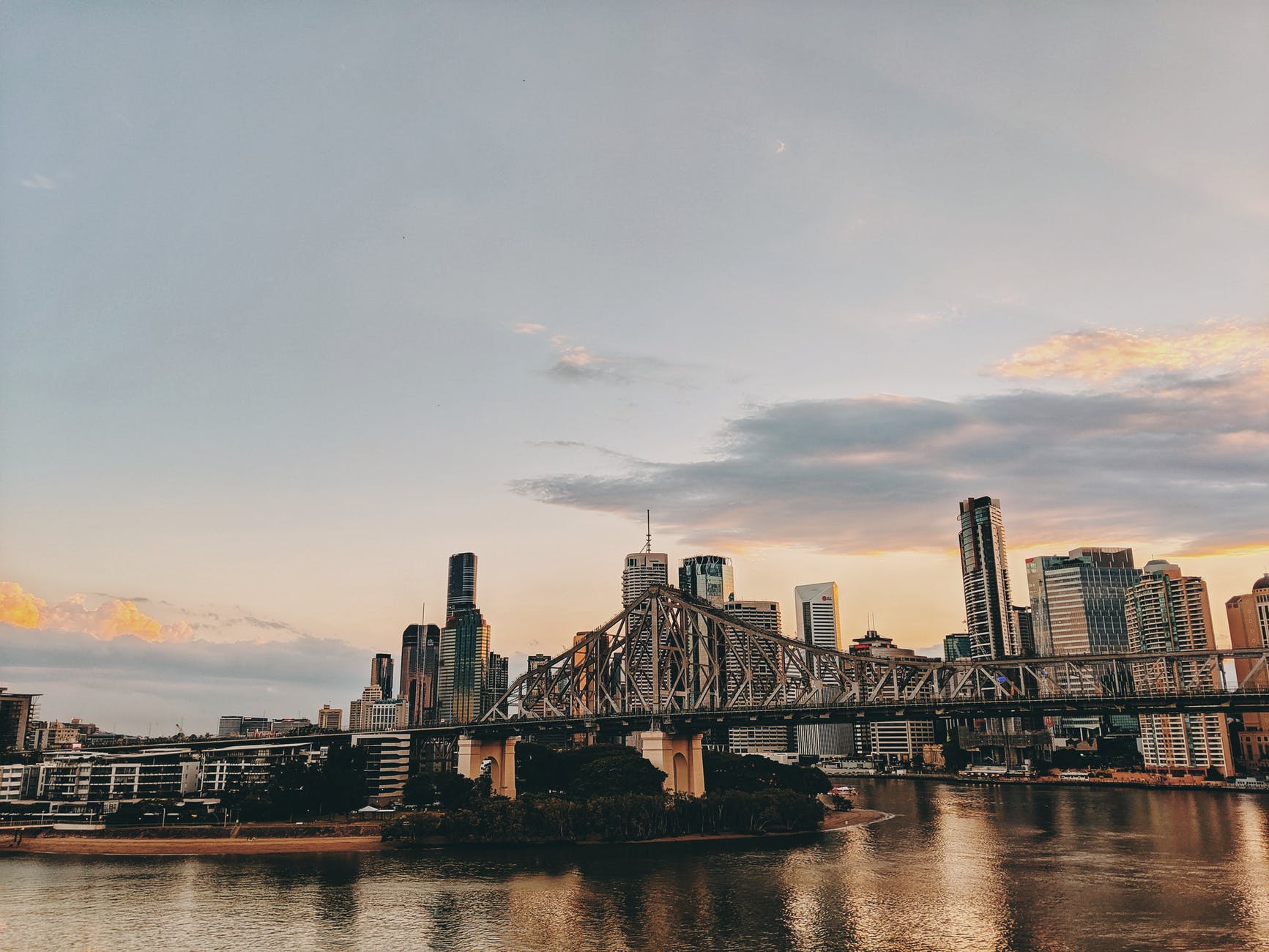 photo of bridge and buildings during golden hour